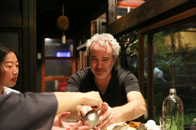 Private Food & Sake Tour in Central Kyoto with Sake Sommelier - Stop 1 in Kyoto: machiya izakaya and standing-bar energy